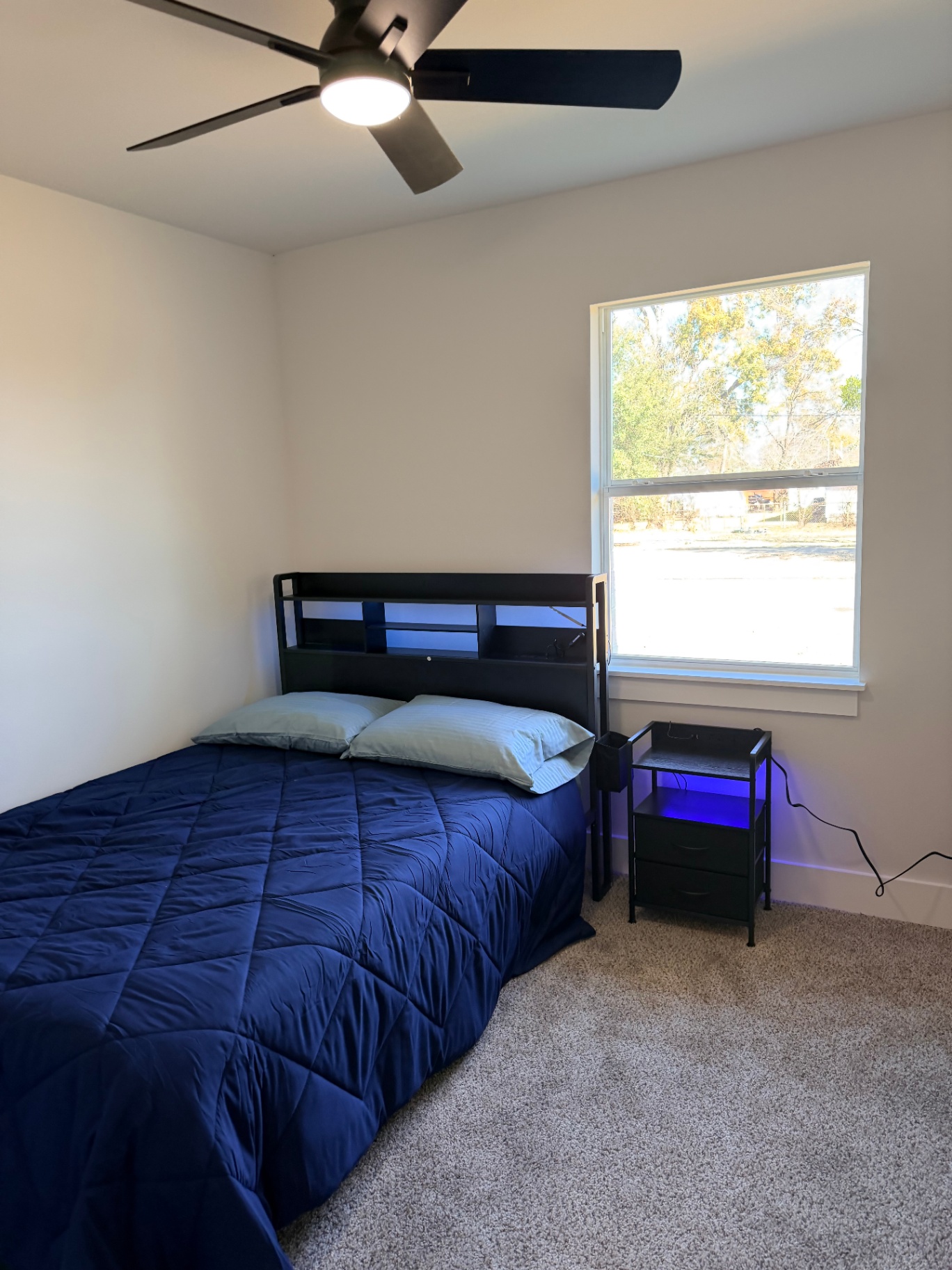 Tilgham House — private bedroom with ceiling fan, queen bed and large window