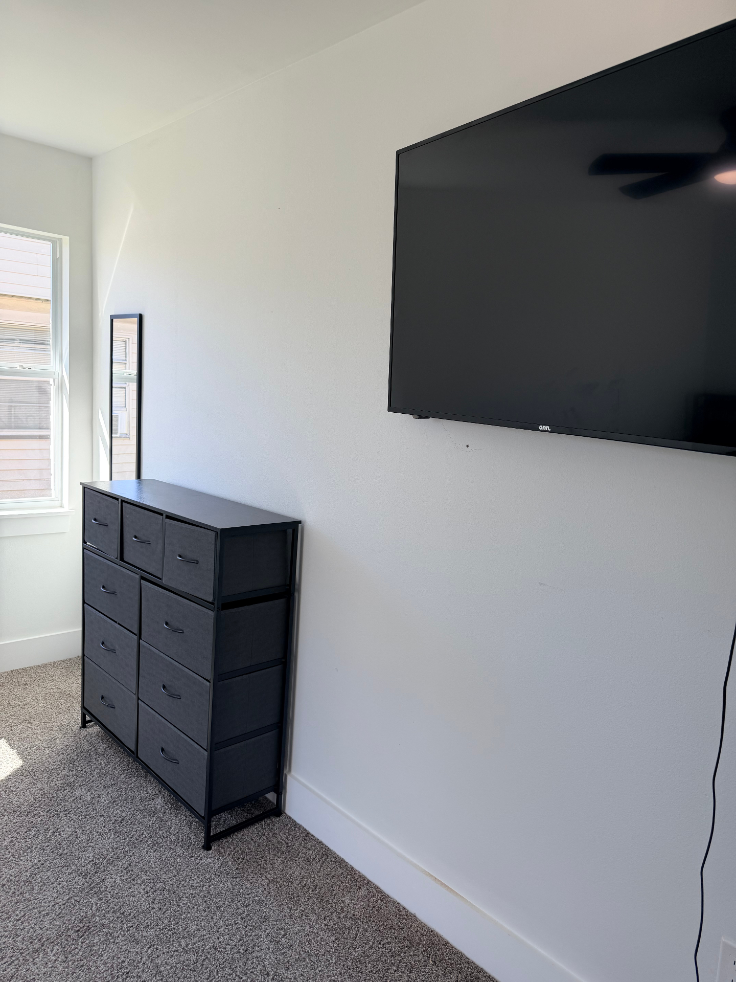 Tilgham House — private bedroom with wall-mounted TV and dresser