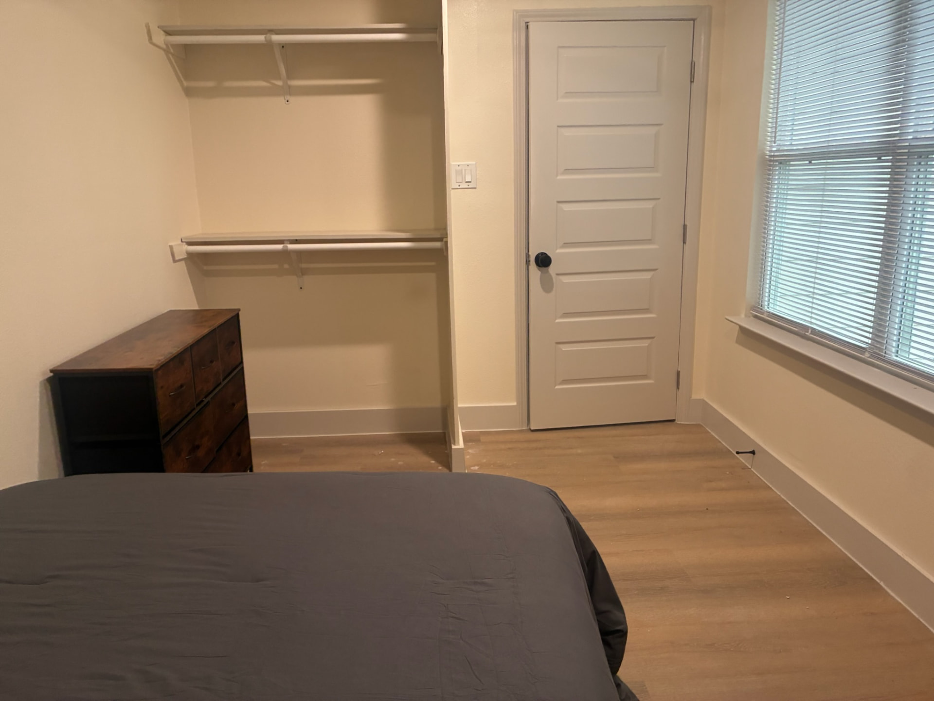 Bedroom closet with double hanging rods and dresser