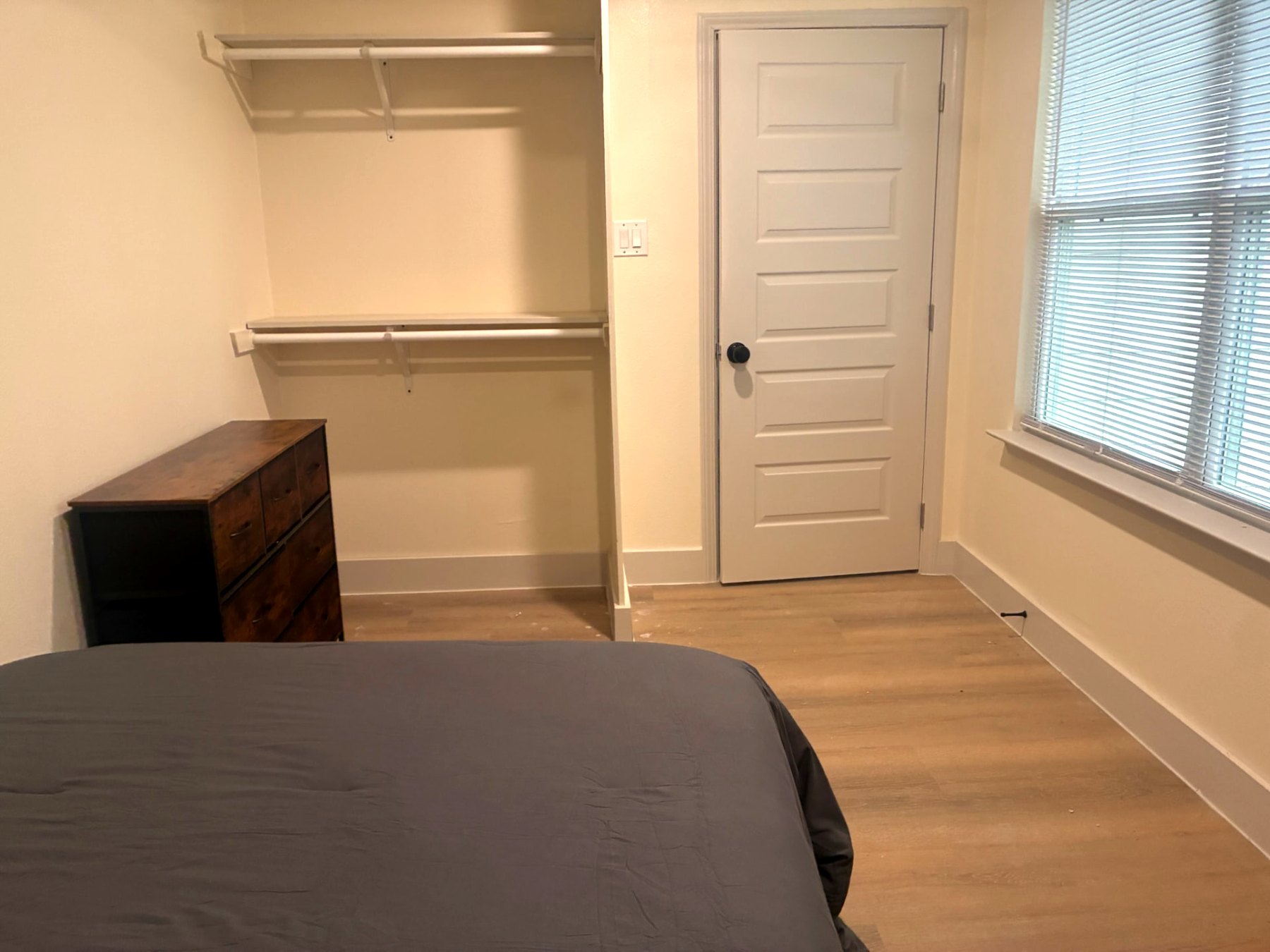 Bedroom closet with double hanging rods and dresser
