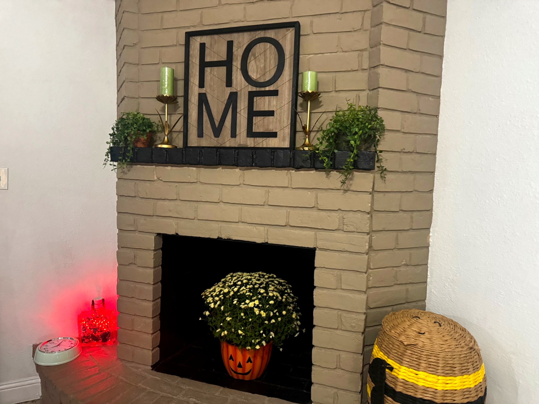 Rinn House — fireplace mantel with HOME sign and greenery