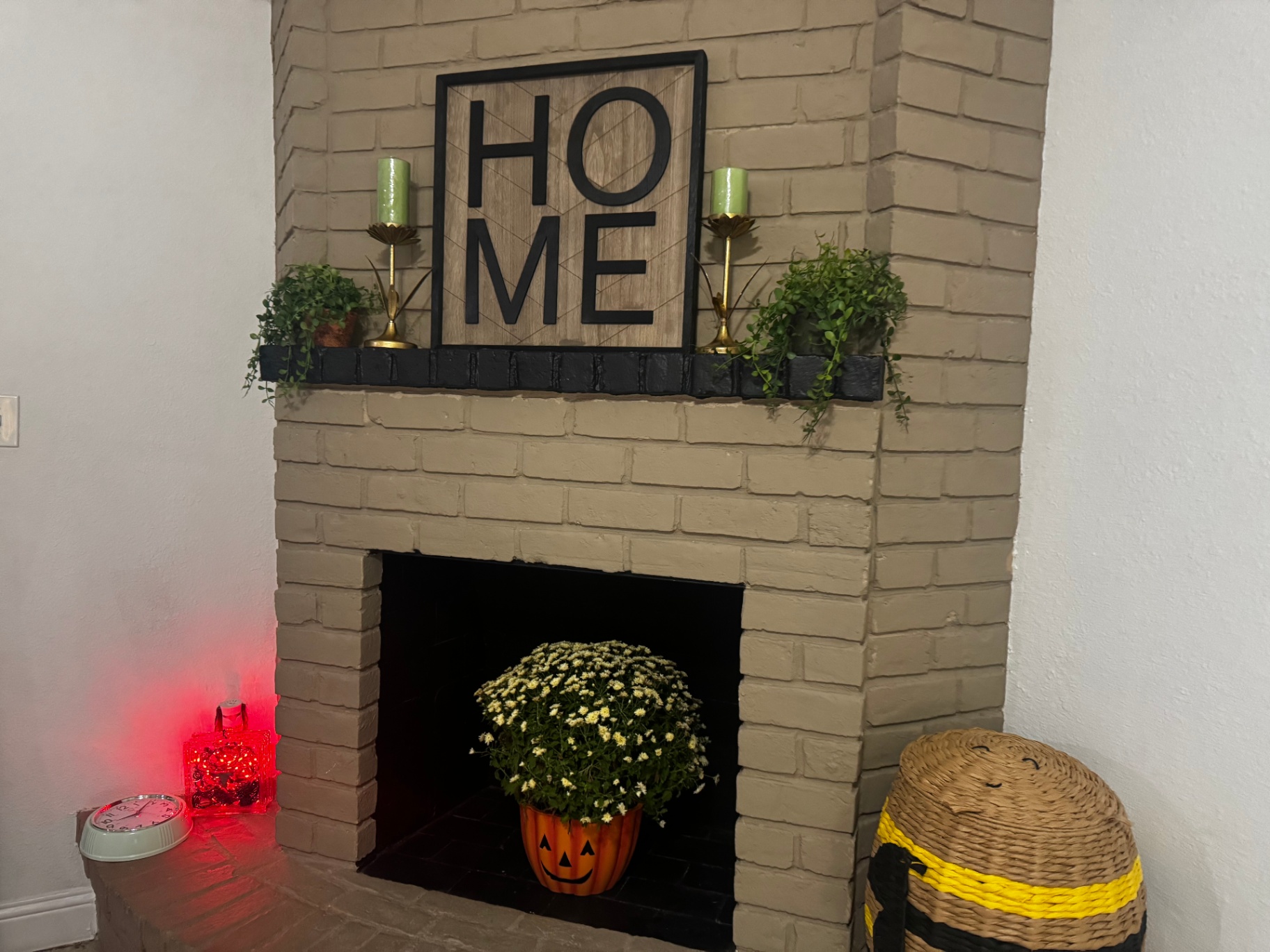 Rinn House — fireplace mantel with HOME sign and greenery
