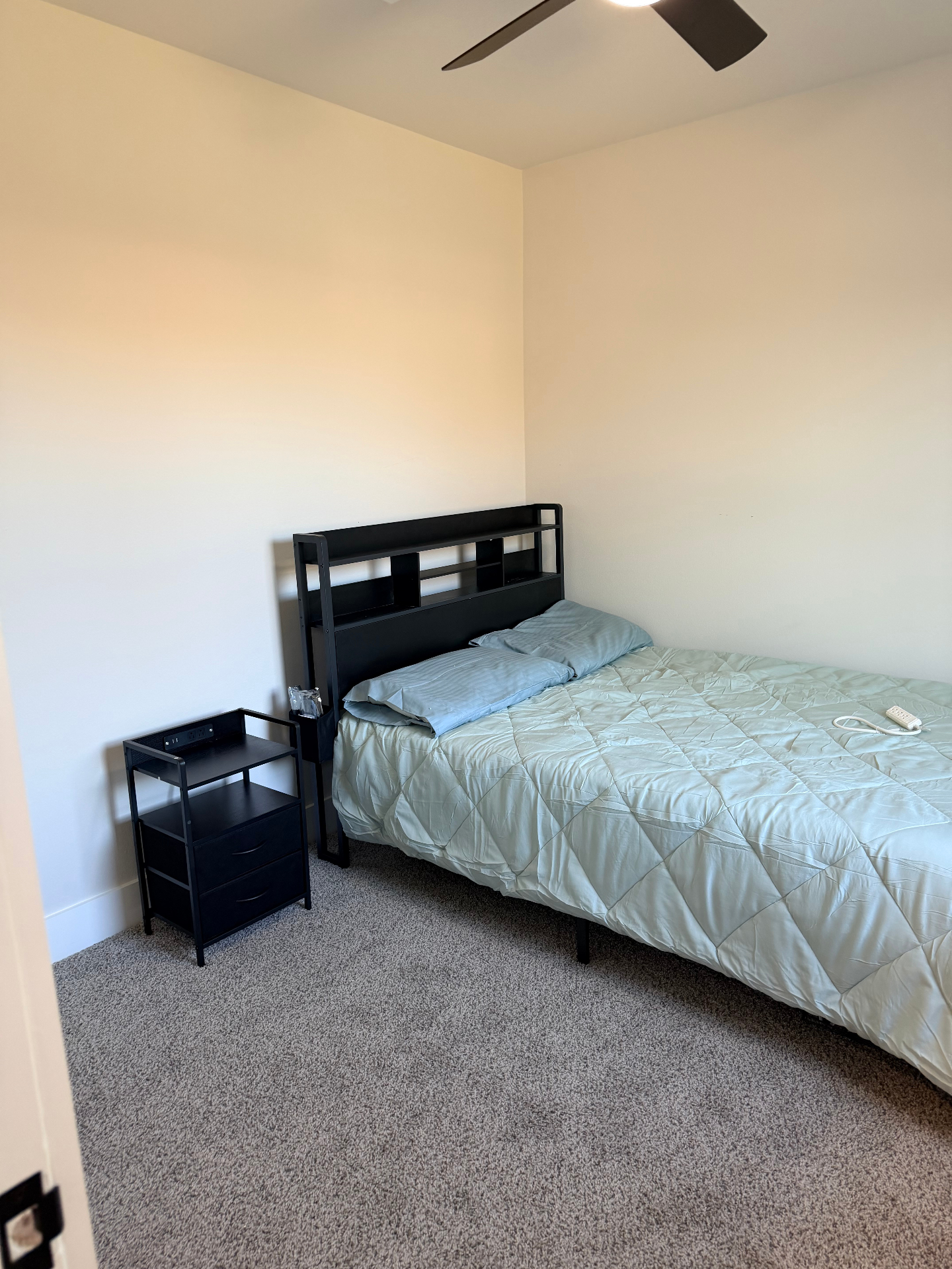 Tilgham House — private bedroom with ceiling fan and bedside charging table
