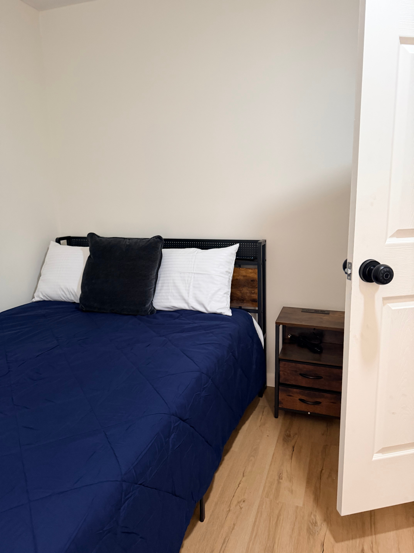 Fairgreen House — cozy bedroom with navy bedding and nightstand