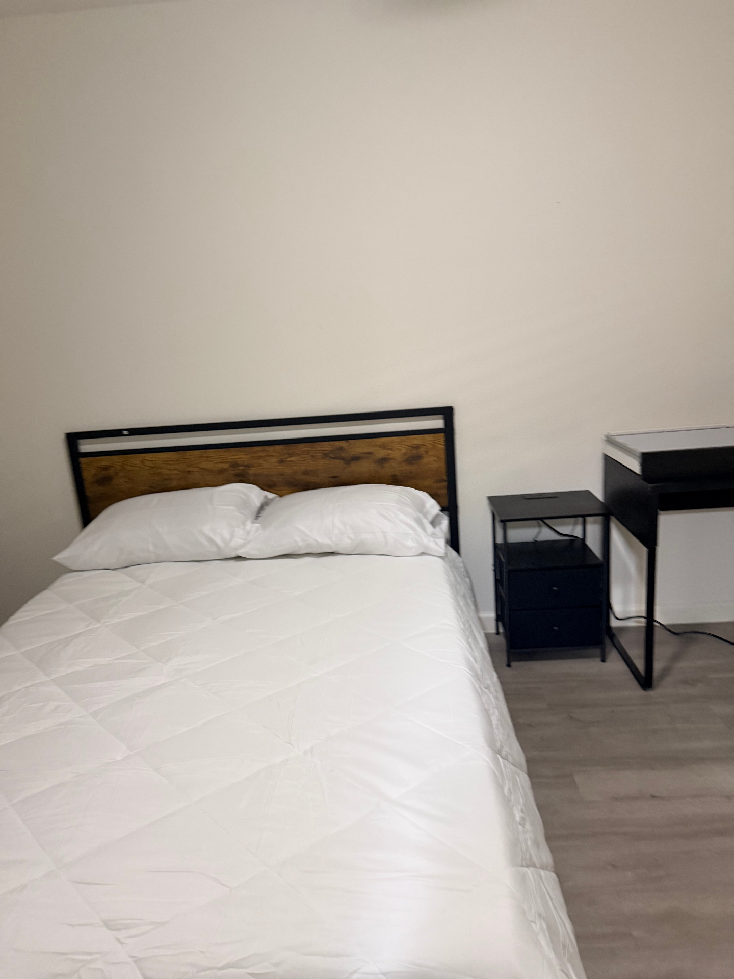 Cosby House — private bedroom with wood-accent headboard and workspace