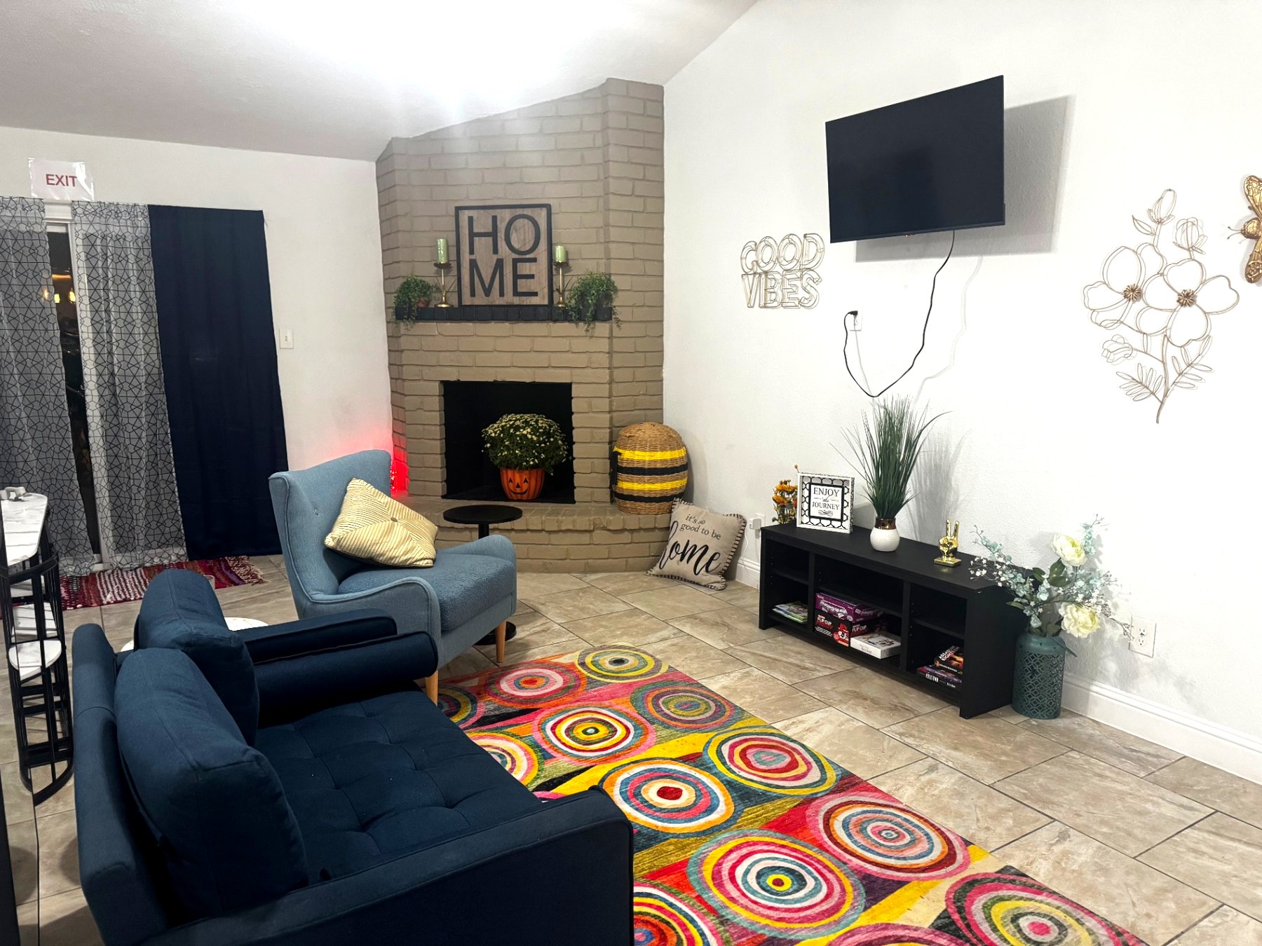 Rinn House — cozy living room with painted brick fireplace