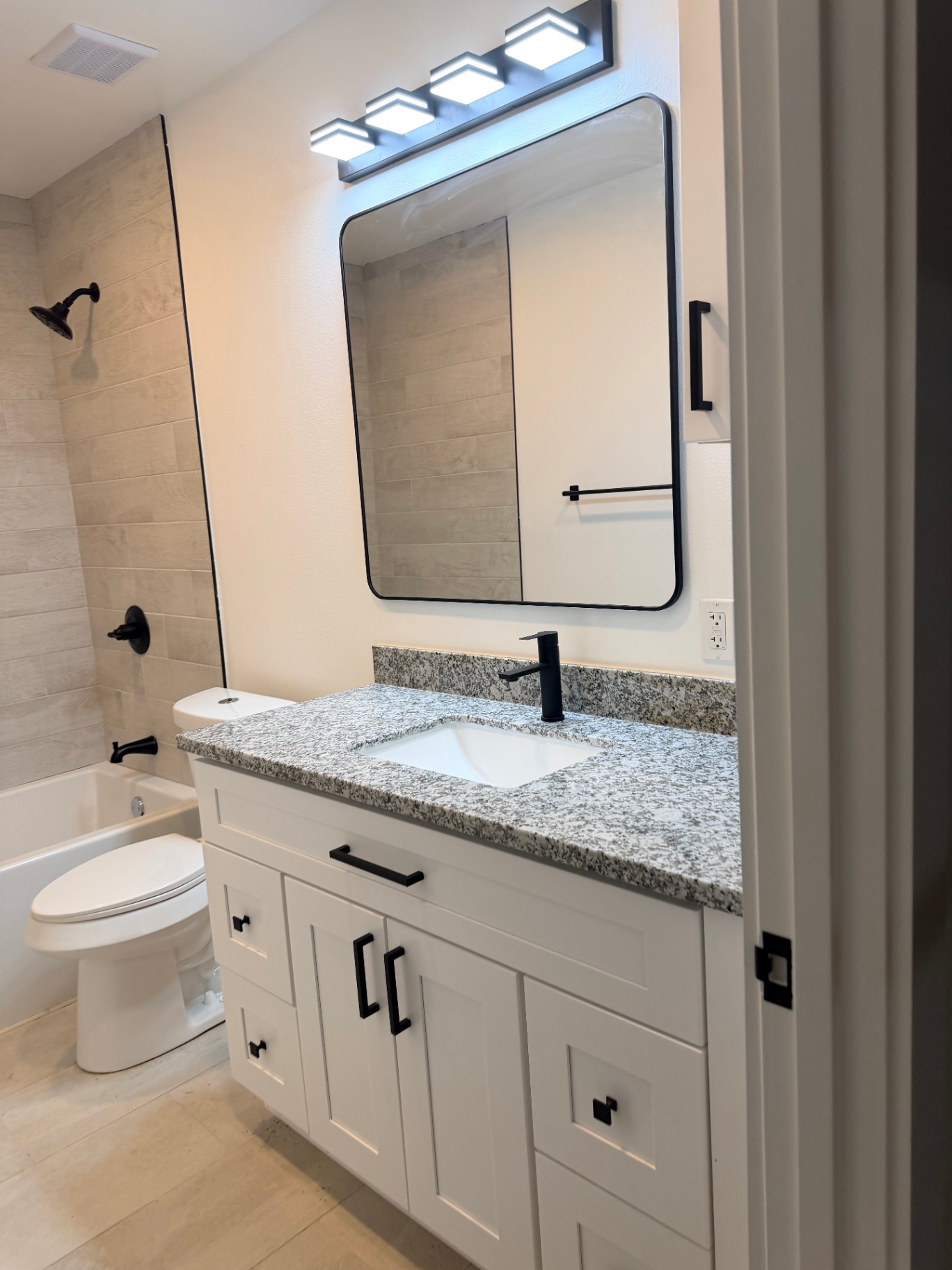 Tilgham House — bathroom with granite vanity and tub/shower
