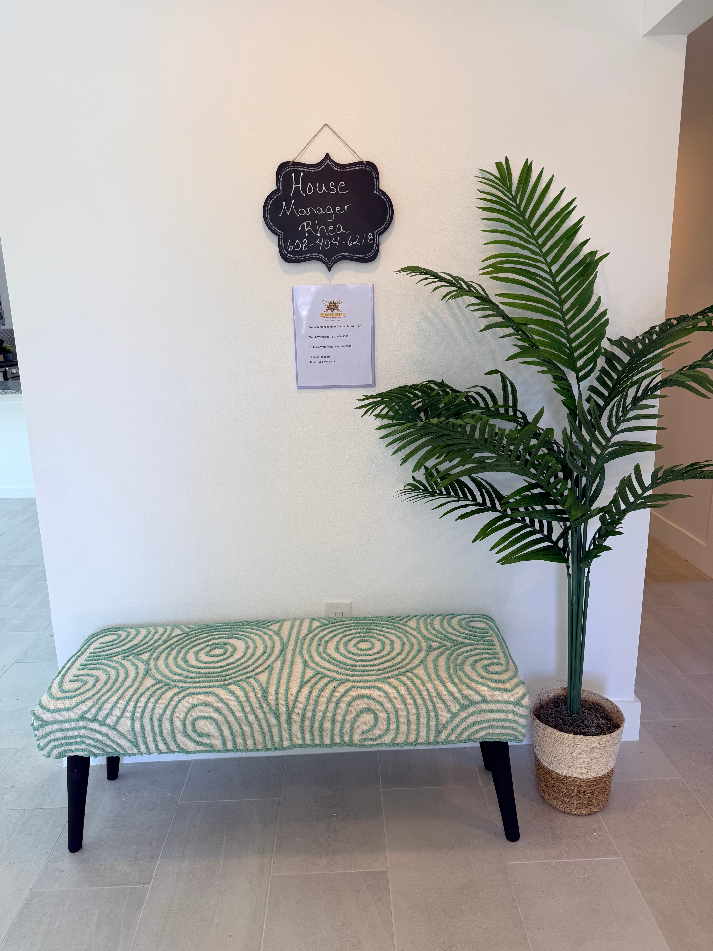 Tilgham House — entryway with house manager chalkboard sign and bench