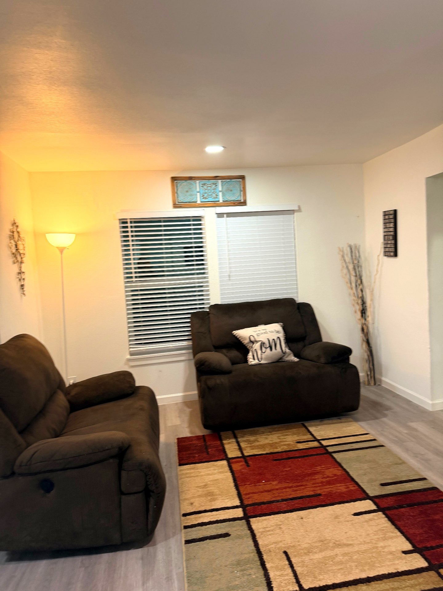 Cosby House — shared living room with warm lamp lighting