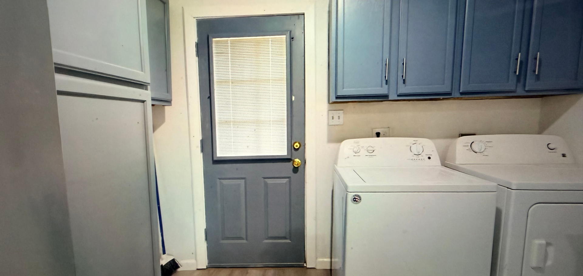 Cosby House — laundry area with washer, dryer and back door