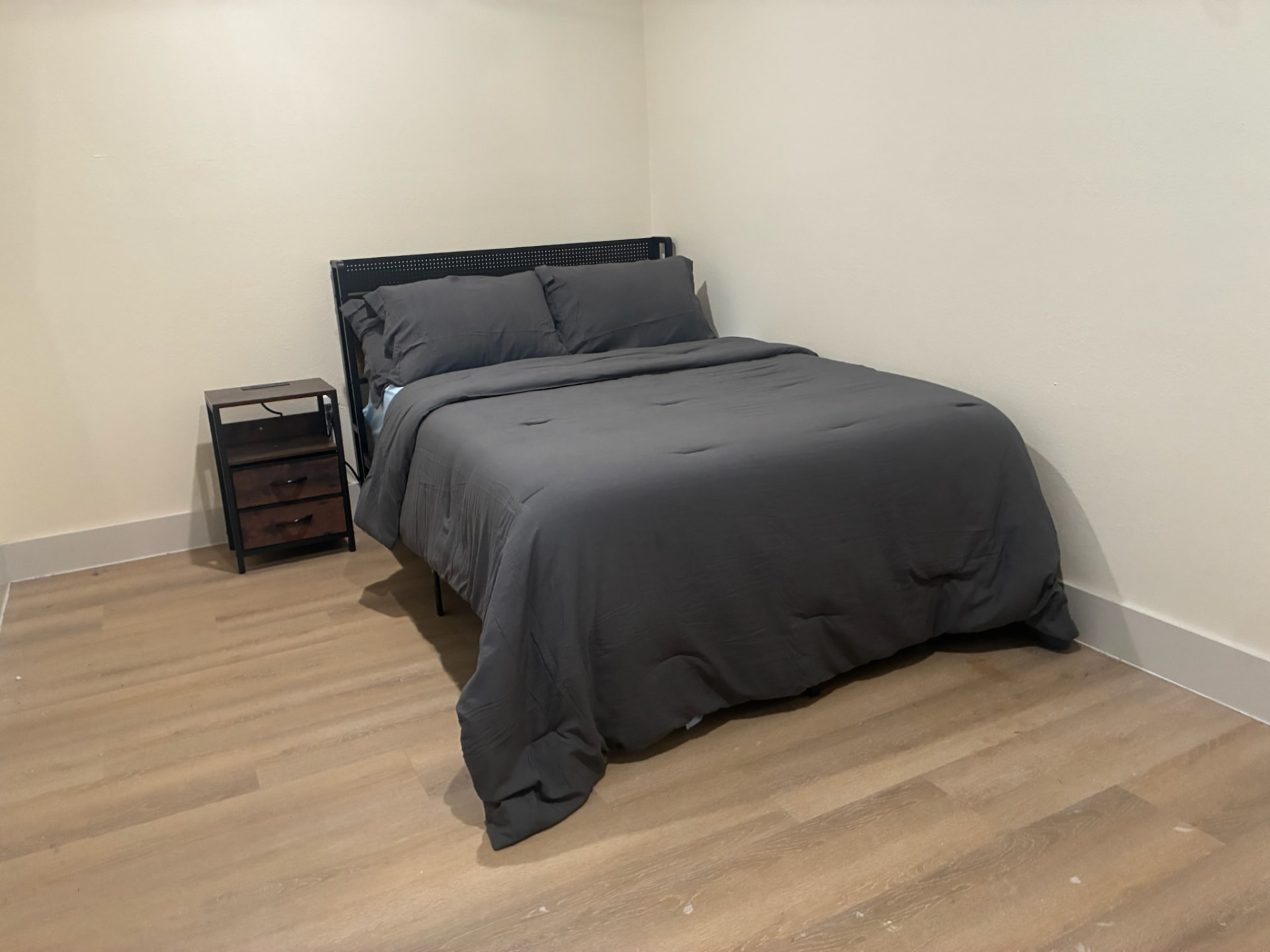 Newly renovated private bedroom with queen bed and nightstand