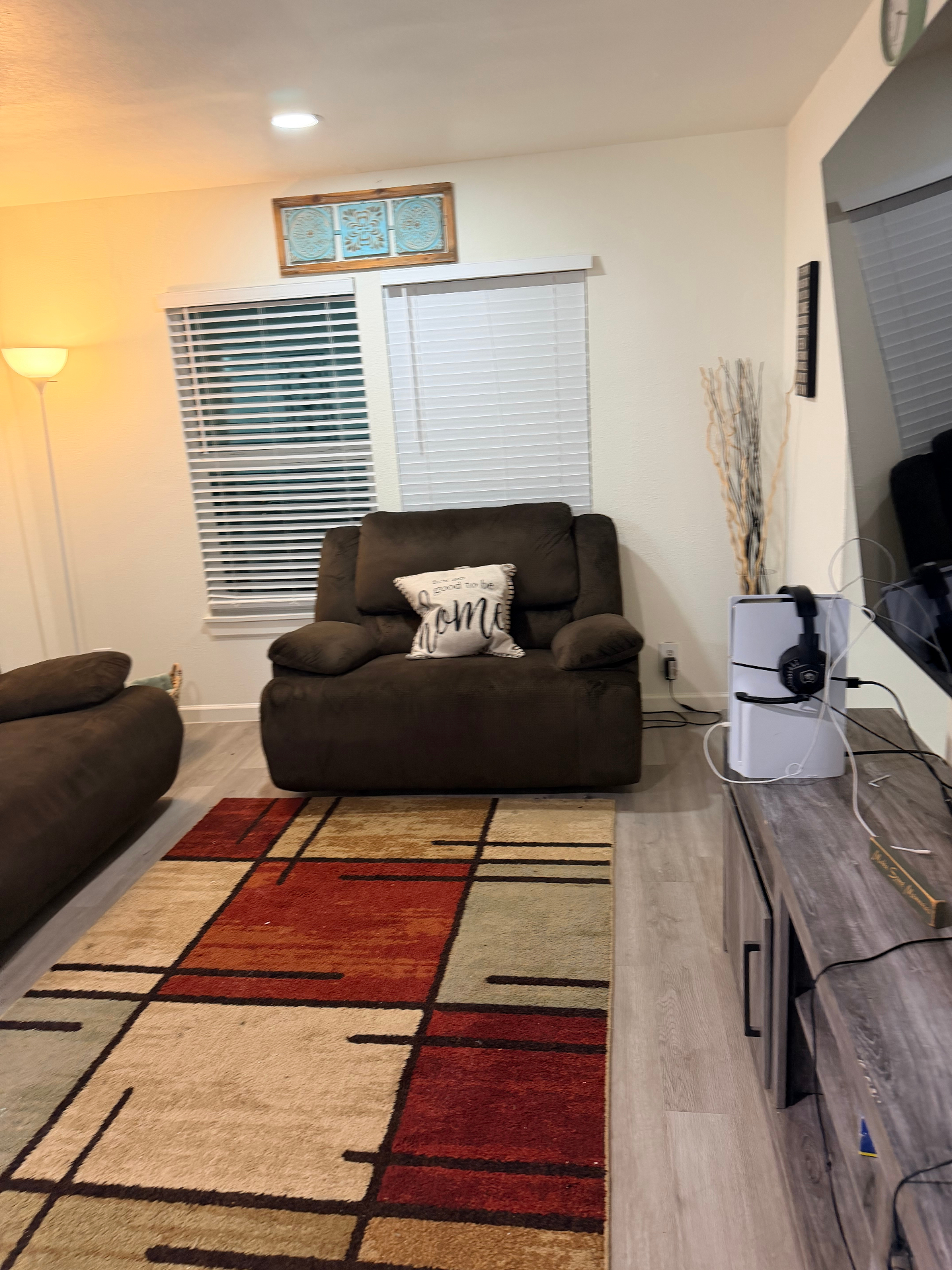 Cosby House — lounge with recliner, area rug and mounted TV setup