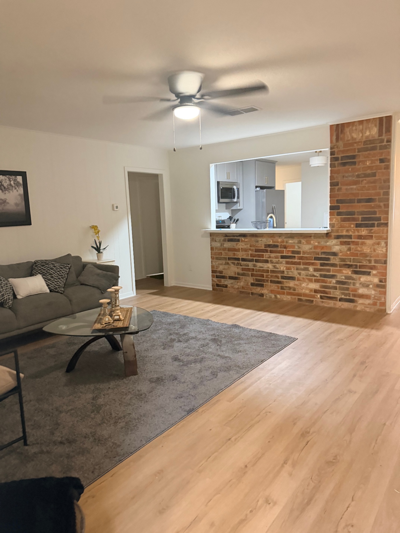 Fairgreen House — open living area with brick accent wall