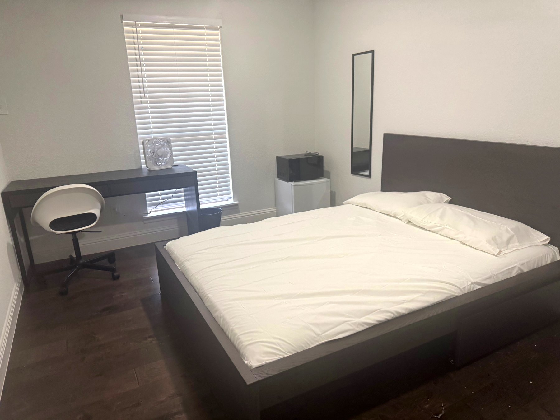Rinn House — furnished private bedroom with queen bed, desk and mini fridge