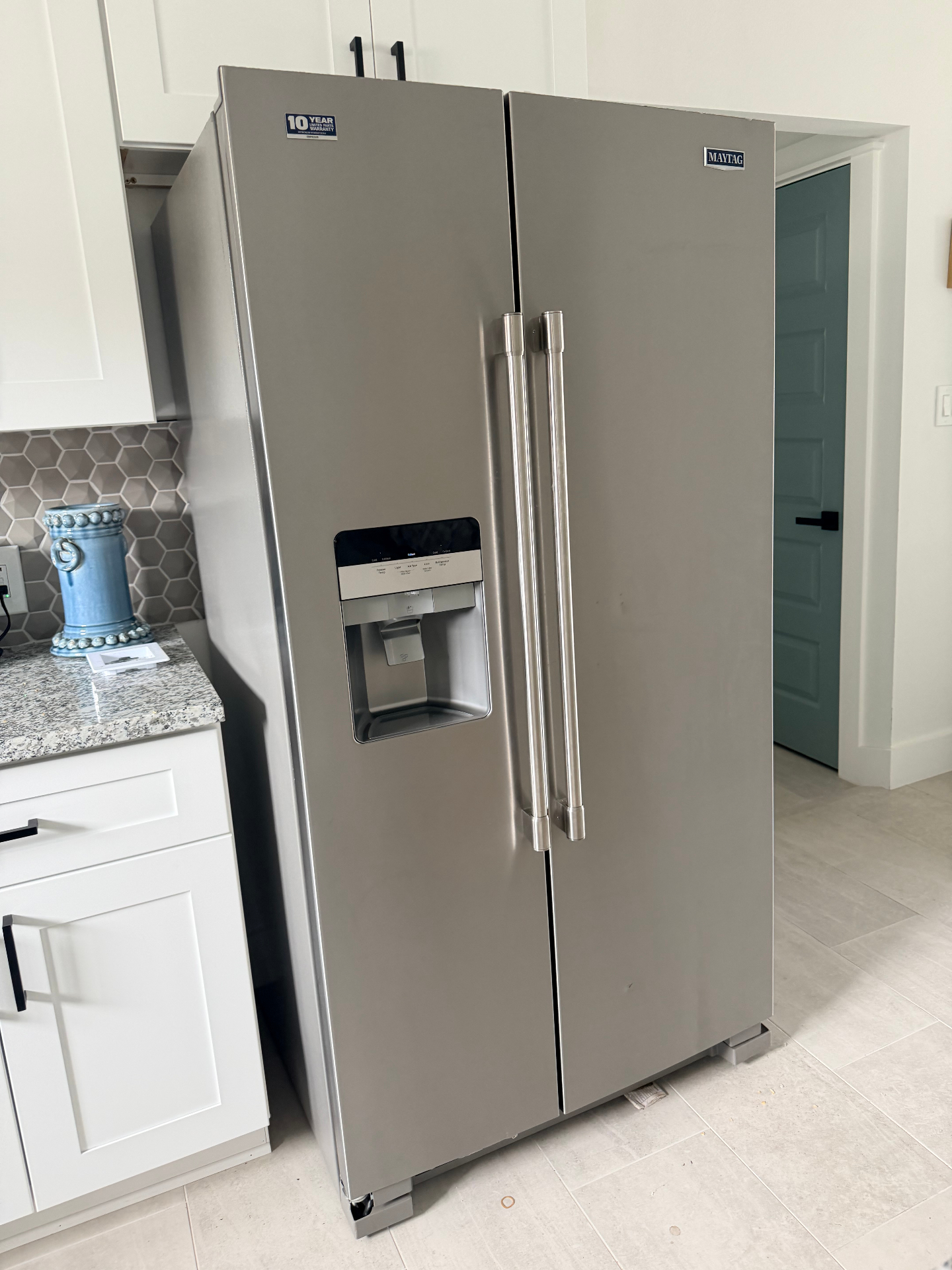 Tilgham House — full-size stainless side-by-side refrigerator with ice and water