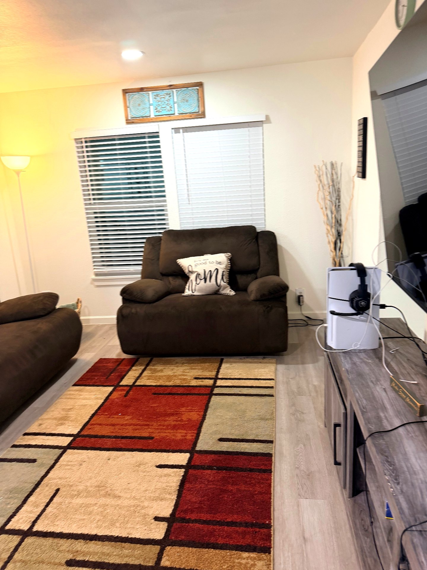 Cosby House — lounge with recliner, area rug and mounted TV setup